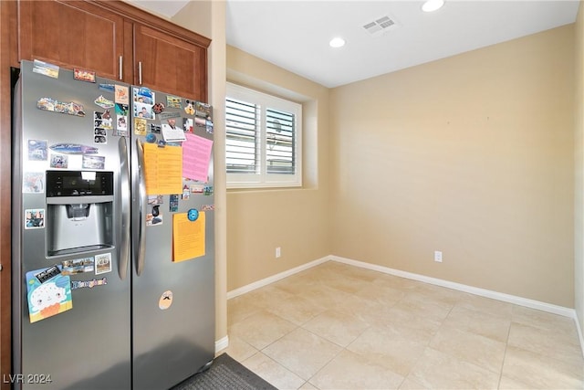 kitchen featuring stainless steel fridge with ice dispenser and light tile patterned floors