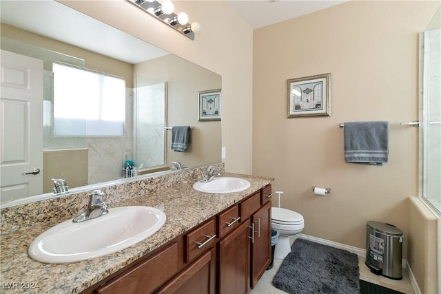 bathroom featuring tile patterned flooring, vanity, toilet, and walk in shower