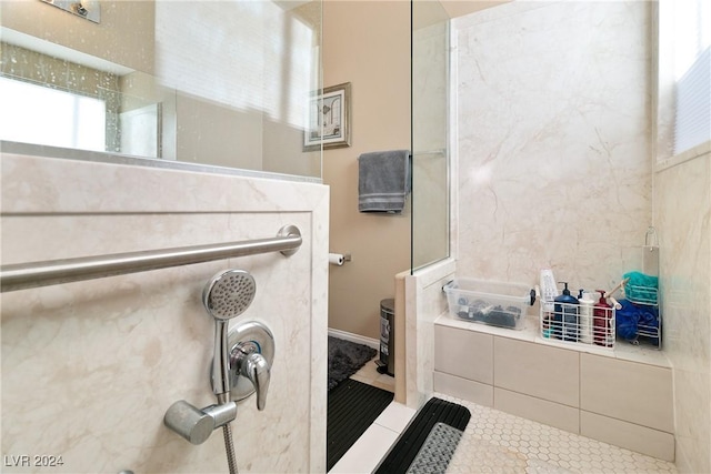 bathroom with tile patterned floors and a shower