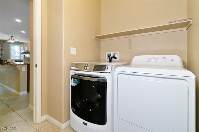 laundry area with light tile patterned floors, separate washer and dryer, and ceiling fan