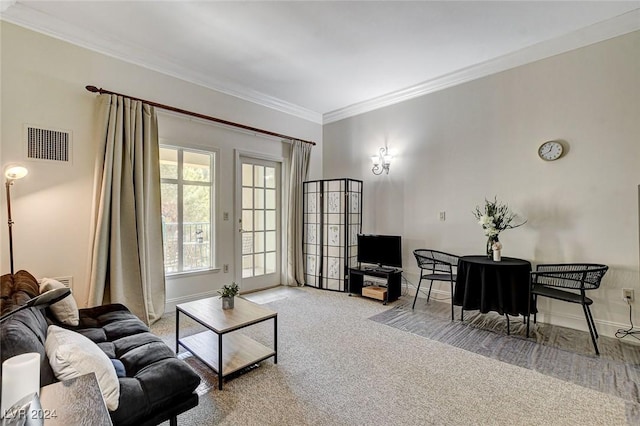 living room with ornamental molding and light carpet