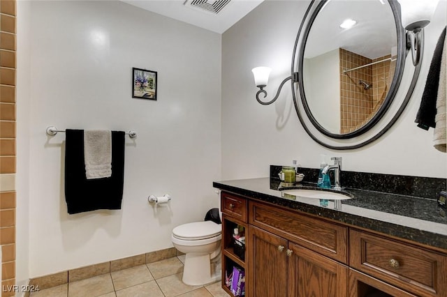 bathroom featuring tile patterned flooring, vanity, and toilet