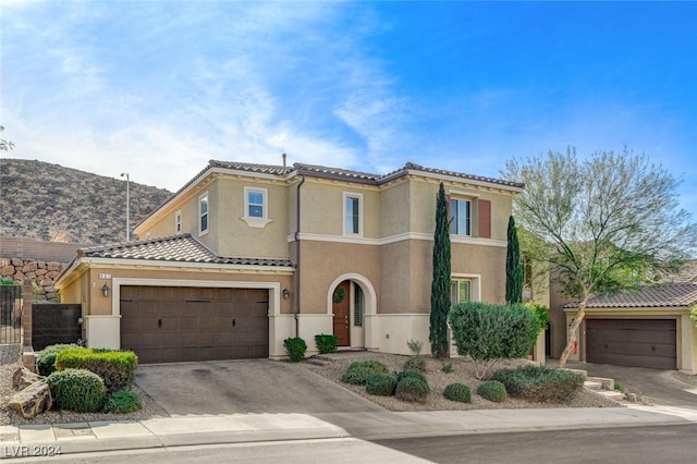 mediterranean / spanish home with a garage