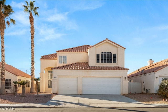 mediterranean / spanish-style home with a garage