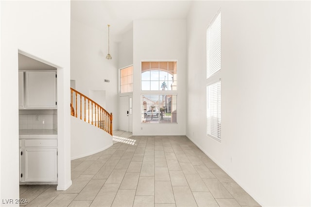 tiled entryway with a high ceiling