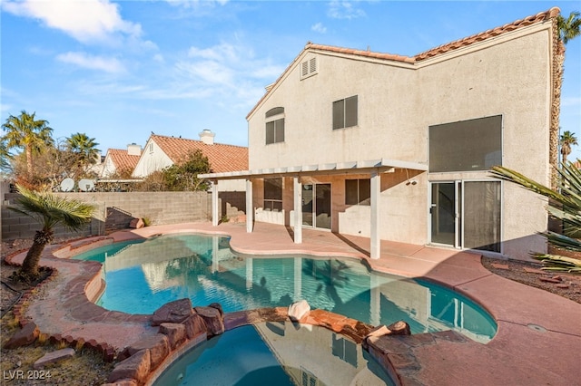 back of house featuring a patio, a fenced in pool, and a pergola