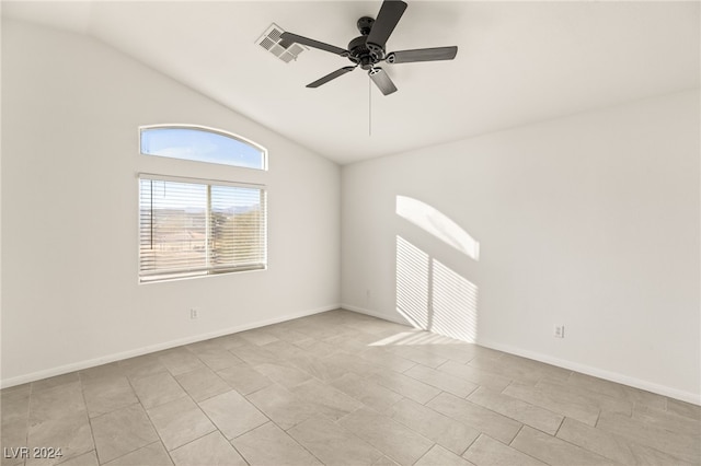 tiled empty room featuring ceiling fan and vaulted ceiling