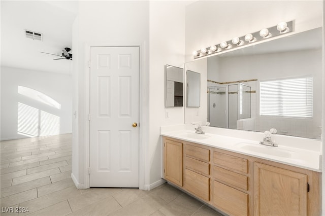 bathroom featuring ceiling fan, walk in shower, tile patterned floors, and vanity