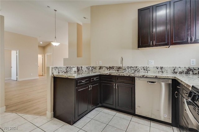 kitchen featuring pendant lighting, sink, dishwasher, light stone countertops, and light tile patterned flooring