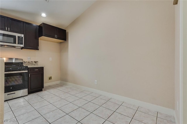 kitchen with appliances with stainless steel finishes and light tile patterned floors