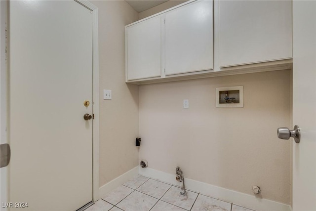 laundry room featuring hookup for a washing machine, light tile patterned floors, and cabinets