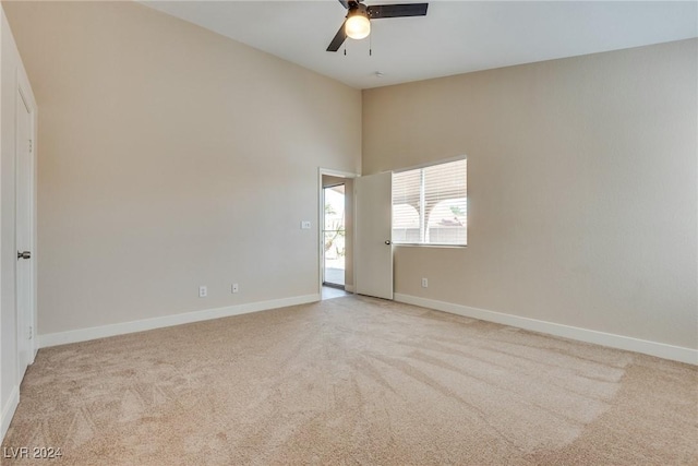 carpeted empty room featuring ceiling fan