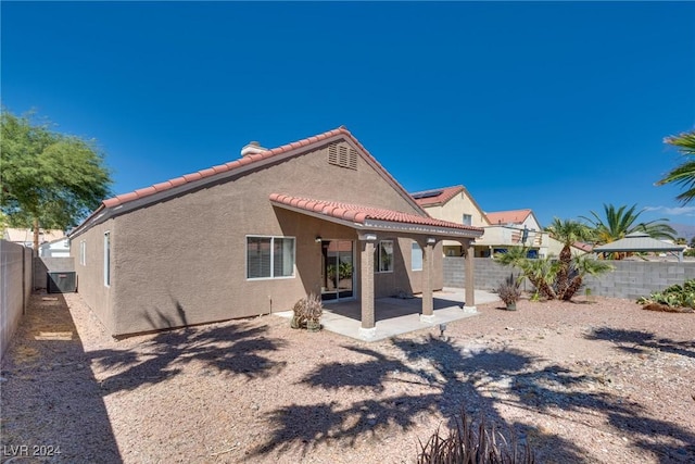 back of property with a patio