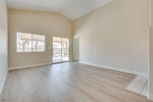 empty room featuring lofted ceiling and light wood-type flooring