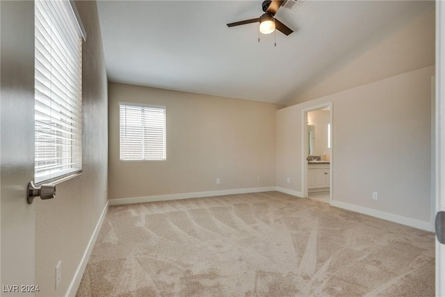 carpeted empty room with lofted ceiling and ceiling fan