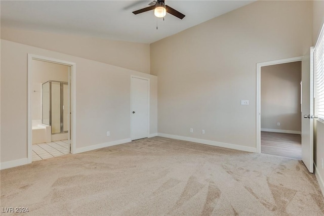 carpeted spare room with high vaulted ceiling and ceiling fan