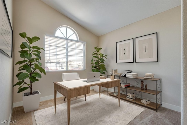 office with carpet floors and vaulted ceiling