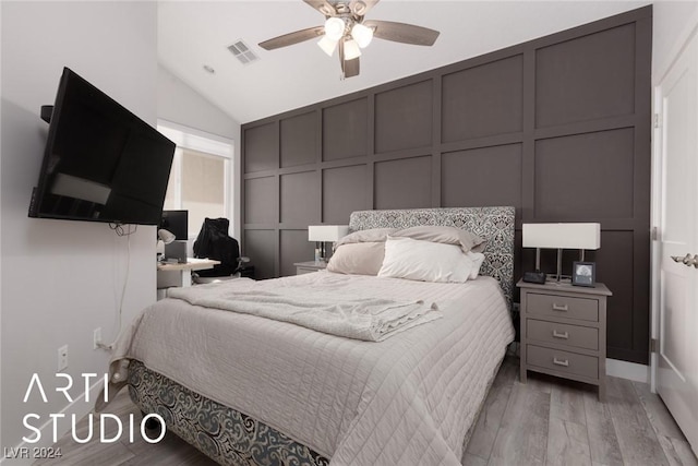 bedroom featuring ceiling fan, vaulted ceiling, and light wood-type flooring