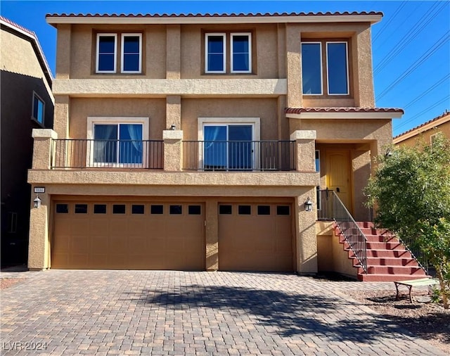 view of front of property with a garage and a balcony