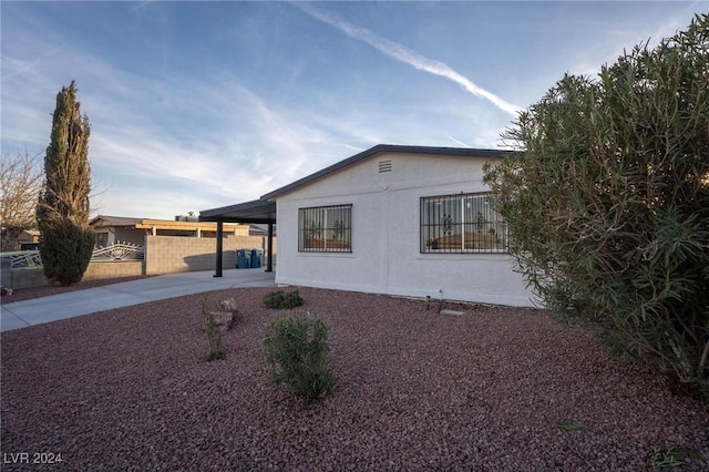 view of side of home with a carport