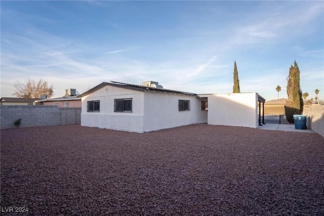 rear view of property with cooling unit