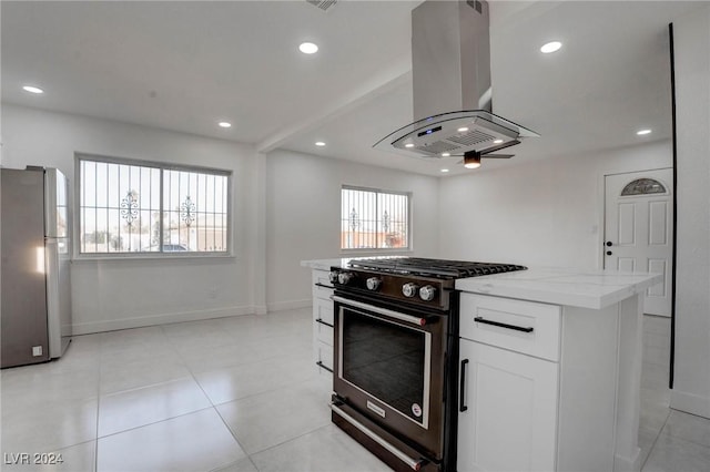 kitchen featuring white cabinetry, a center island, high end black range, stainless steel fridge, and island range hood