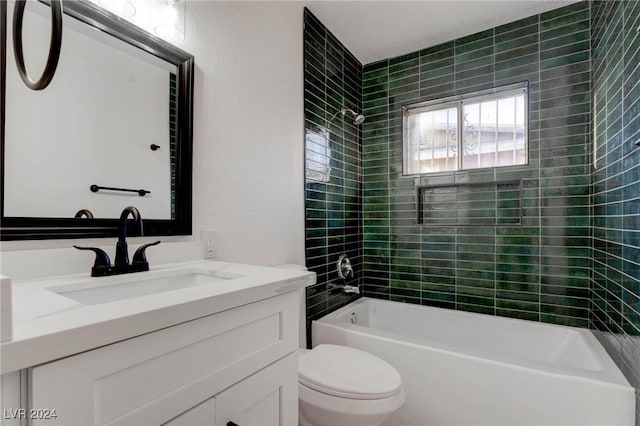 full bathroom with vanity, tiled shower / bath, and toilet