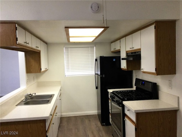 kitchen featuring white cabinets, light hardwood / wood-style flooring, sink, and stainless steel gas range