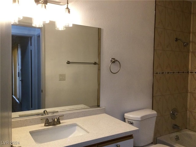 full bathroom with vanity, toilet, and tiled shower / bath