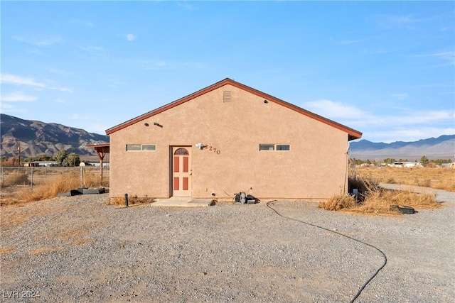 back of house with a mountain view