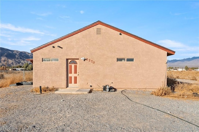 rear view of property featuring a mountain view