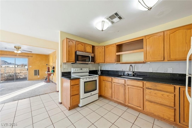 kitchen featuring white electric range oven, ceiling fan, light tile patterned flooring, and sink