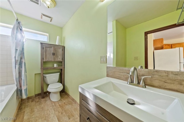 full bathroom featuring shower / bath combination with curtain, vanity, hardwood / wood-style flooring, and toilet