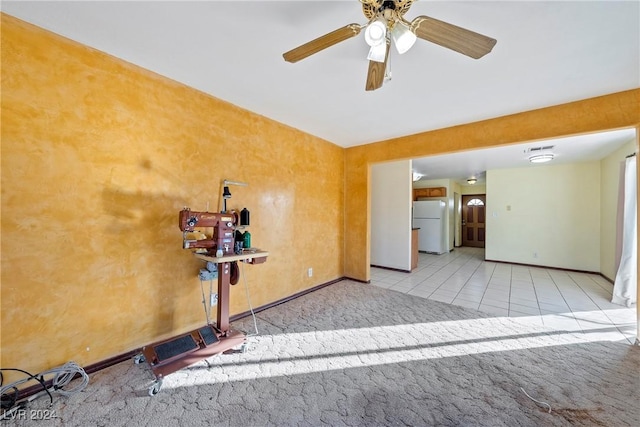 unfurnished room with ceiling fan and light carpet