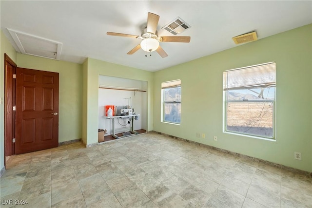 unfurnished bedroom featuring ceiling fan, a closet, and multiple windows