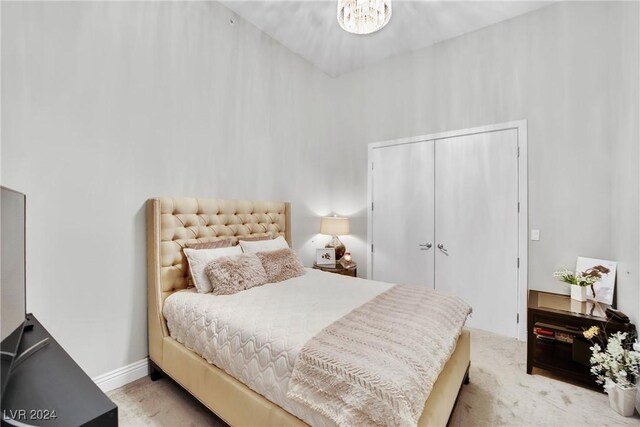 carpeted bedroom featuring an inviting chandelier