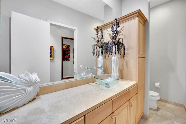 bathroom featuring tile patterned flooring, vanity, and toilet