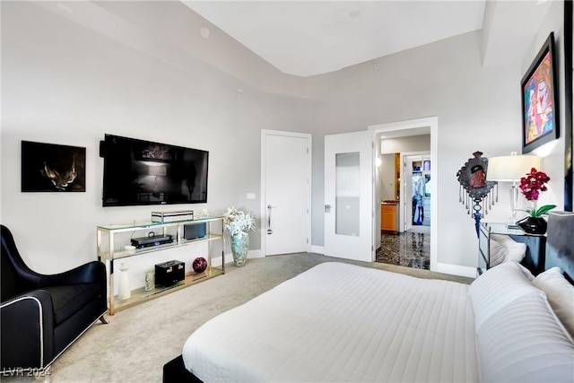 carpeted bedroom featuring ensuite bath