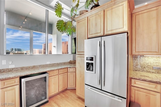 kitchen featuring wine cooler, stainless steel fridge with ice dispenser, light hardwood / wood-style flooring, and light brown cabinetry