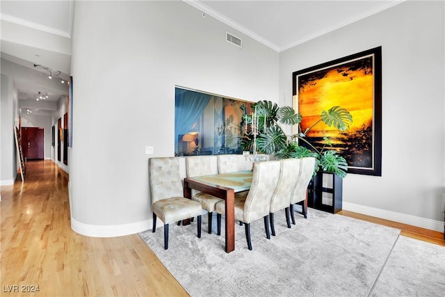 dining area featuring hardwood / wood-style flooring and ornamental molding