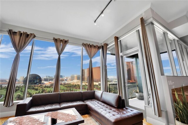 unfurnished sunroom with rail lighting