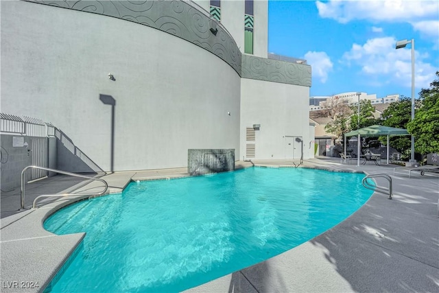 view of pool featuring a gazebo, a patio area, and pool water feature