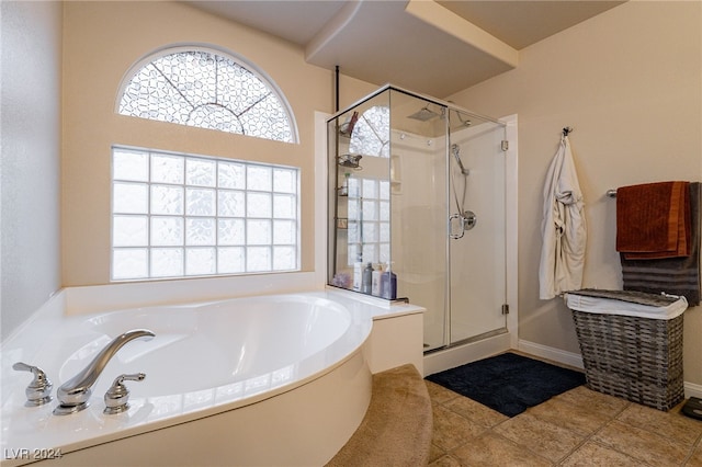 bathroom featuring tile patterned flooring, a wealth of natural light, and independent shower and bath