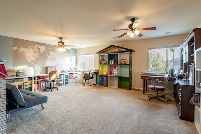 interior space featuring ceiling fan, light colored carpet, and a textured ceiling