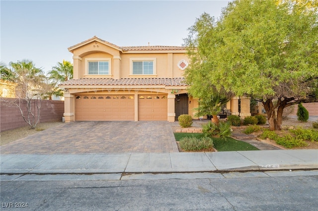 mediterranean / spanish-style home with a garage