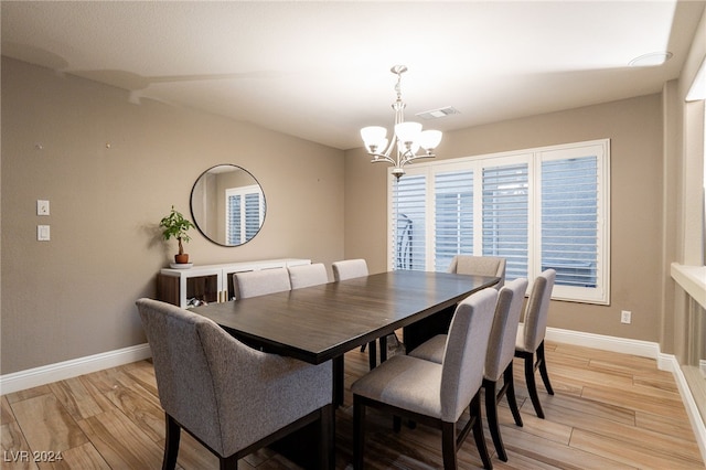 dining area featuring a chandelier and light hardwood / wood-style floors