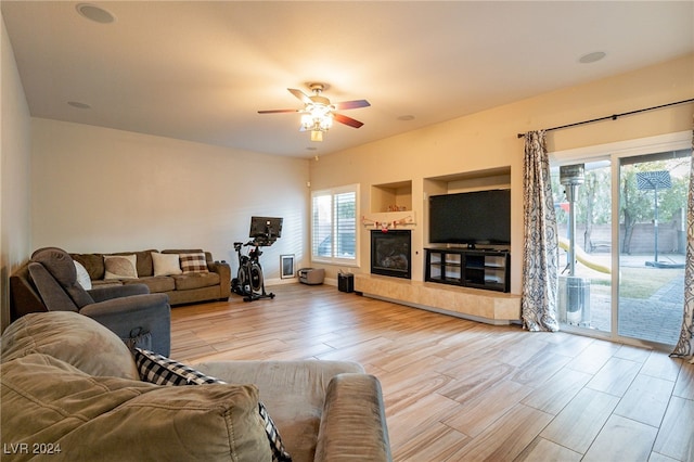 living room with ceiling fan and light hardwood / wood-style flooring