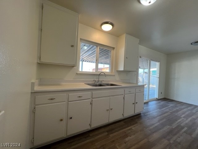 kitchen featuring white cabinetry, sink, and dark wood-type flooring