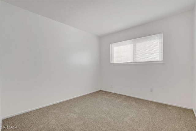 empty room with light colored carpet