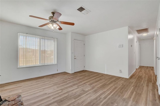 empty room featuring ceiling fan and light wood-type flooring